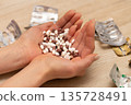 Woman's hand holding a lot of medicine 135728491