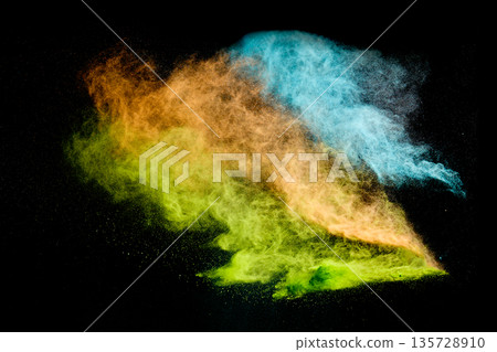 Colorful powder exploding creating vibrant dust cloud Colorful powder exploding creating vibrant dust cloud 135728910