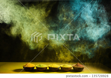 Colorful powder explosion above spice bowls 135728928