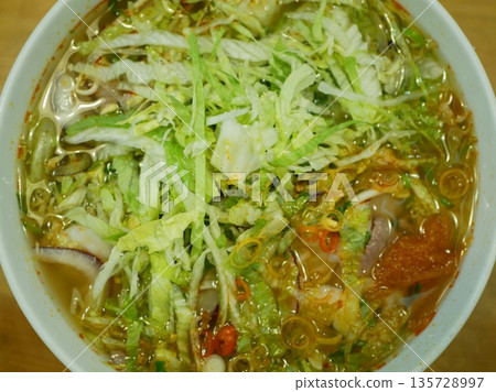 Vietnamese soup tomato noodle fast food chili in a big bowl using spoon or chopstick snapshot photo. Traditional Vietnamese soup that is flavorful comforting nutritious vegetarian savory sweet Vietnamese soup tomato noodle fast food chili in a big bowl using spoon or chopstick snapshot photo. Traditional Vietnamese soup that is flavorful comforting nutritious vegetarian savory sweet 135728997