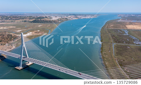 Drone captures Guadiana International Bridge connecting Portugal and Spain, showcasing the river and surrounding landscape in Algarve region Drone captures Guadiana International Bridge connecting Portugal and Spain, showcasing the river and surrounding landscape in Algarve region 135729086