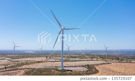 Wind green energy. Wind turbines standing tall in a vast landscape, showcasing renewable energy generation and the promise of a sustainable future 135729107