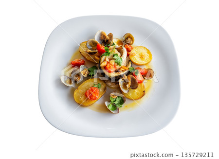 Delicious seafood dish featuring clams, shrimp, and vegetables on a white plate, showcasing vibrant colors and culinary artistry Delicious seafood dish featuring clams, shrimp, and vegetables on a white plate, showcasing vibrant colors and culinary artistry 135729211