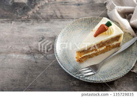Carrot cake slice with cream cheese frosting 135729835