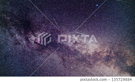 Perseid meteors visible over milky way background in region near Cygnus constellation 135729884