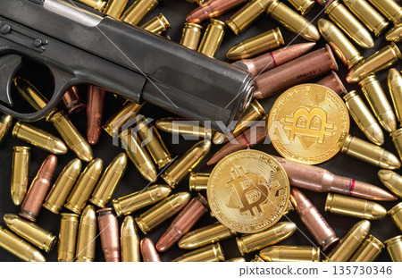 Bronze and brass gun bullets scattered on dark table, black pistol barrel, golden bitcoin coins near - illegal use of cryptocurrency to purchase weapon concept Bronze and brass gun bullets scattered on dark table, black pistol barrel, golden bitcoin coins near - illegal use of cryptocurrency to purchase weapon concept 135730346