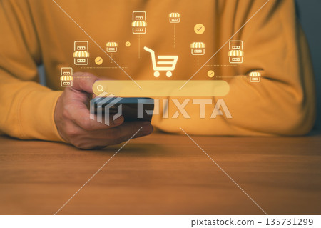 Close-up of person using smartphone with search, shopping cart and store icons, symbolizing mobile e-commerce. Concept for online shopping, digital marketplace, and smart retail business technology. Close-up of person using smartphone with search, shopping cart and store icons, symbolizing mobile e-commerce. Concept for online shopping, digital marketplace, and smart retail business technology. 135731299