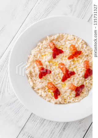 Creamy Italian risotto topped with crawfish tails and olive oil, bright gourmet styling Creamy Italian risotto topped with crawfish tails and olive oil, bright gourmet styling 135731327