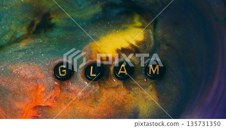 Glam word. Paint spill. Defocused yellow orange purple color glitter letters water black mix glamour texture sparkling droplet on abstract background. Glam word. Paint spill. Defocused yellow orange purple color glitter letters water black mix glamour texture sparkling droplet on abstract background. 135731350