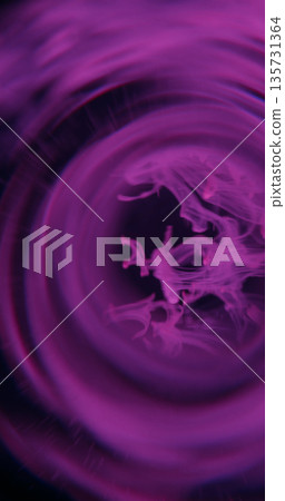 Paint drop defocused. Smoke whirl. Color fume blob drop floating in round frame on black background. Neon purple glow abstract swirl. Paint drop defocused. Smoke whirl. Color fume blob drop floating in round frame on black background. Neon purple glow abstract swirl. 135731364