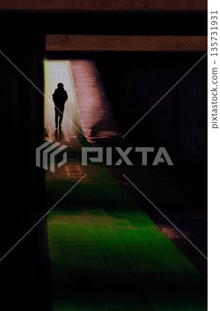 People walking through an underpass that resembles a tunnel of light People walking through an underpass that resembles a tunnel of light 135731931