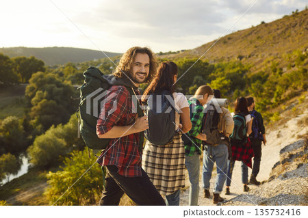 Portrait of a Happy Hiker in Friends Company during Mountain Adventure 135732416