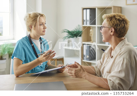 Elderly patients visit to doctor to discuss medical diagnosis and treatment plan 135733264