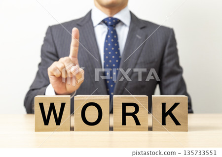 A block with the word "WORK" written on it and a businessman A block with the word "WORK" written on it and a businessman 135733551