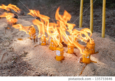 Candles while burning on the ground during Lanna traditional worship ceremony in Northern region of Thailand. In Lanna region of Thailand they believed burning the candle in ceremony to remove bad luc 135733646