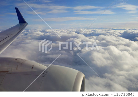 A view above the clouds from the window of a passenger plane 135736045