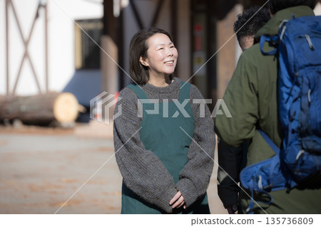 A woman who runs a guesthouse or pension in the countryside, and who is responsible for customer service, reception, and check-in 135736809