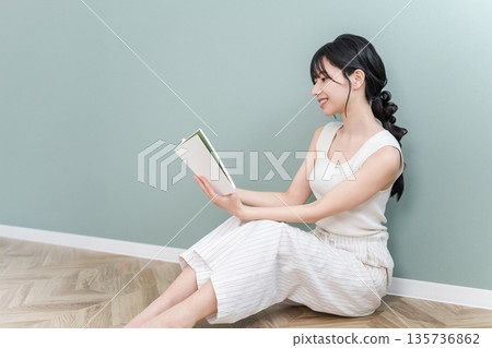 Young Asian woman reading at home (culture, reading habits, spare time, literature) Young Asian woman reading at home (culture, reading habits, spare time, literature) 135736862