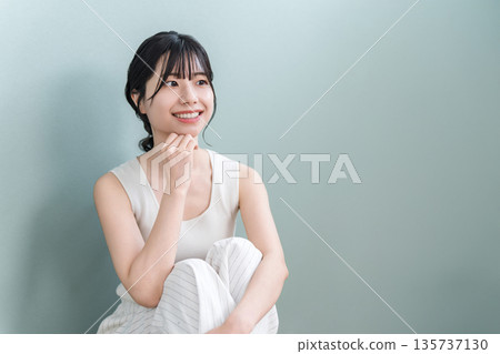 Smiling Asian woman with beautiful skin with a cheek (beauty, esthetic, skin care image) Smiling Asian woman with beautiful skin with a cheek (beauty, esthetic, skin care image) 135737130