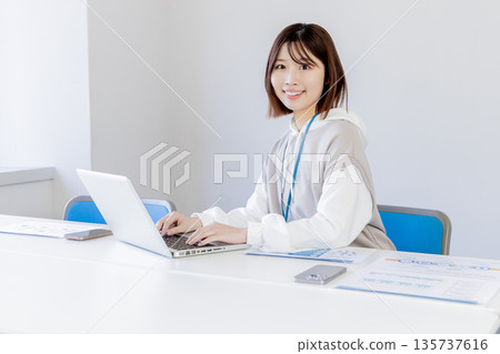 A woman using a computer 135737616