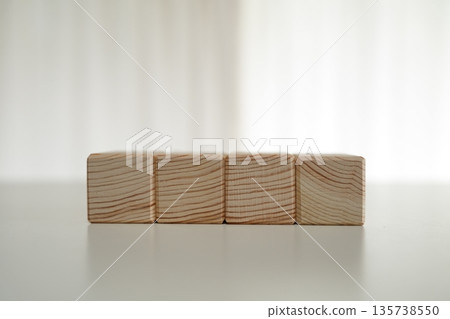 Kumiki wooden blocks lined up on a white table Kumiki wooden blocks lined up on a white table 135738550