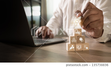 ISO quality certification and compliance concept document control and verified badge, businessman points to ISO blocks, showing quality assurance and audit readiness. 135738836