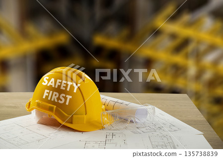 Safety First Construction manager shows a yellow hard hat on blueprints with safety goggles, highlighting PPE compliance, site planning, and risk management in industry. Safety First Construction manager shows a yellow hard hat on blueprints with safety goggles, highlighting PPE compliance, site planning, and risk management in industry. 135738839