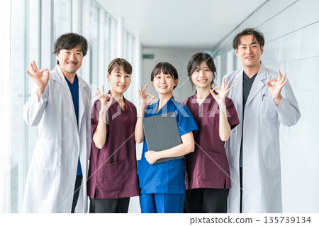 Medical workers in scrubs, medical staff, female nurses and male doctors in white coats Medical workers in scrubs, medical staff, female nurses and male doctors in white coats 135739134
