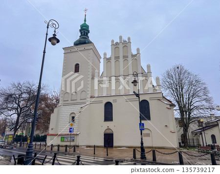 Historic church building with unique design in a city square on a cloudy day Historic church building with unique design in a city square on a cloudy day 135739217