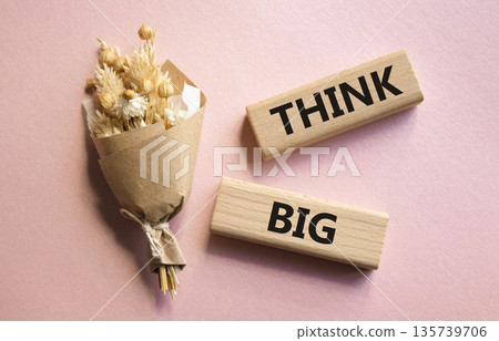 Think big symbol. Wooden blocks with words Think big. Beautiful pink background. Business and Think big concept. Copy space. 135739706