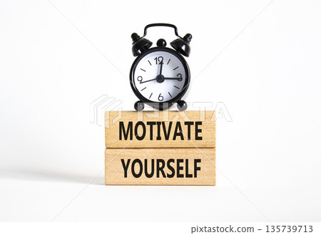 Motivation symbol. Concept words Motivate yourself on wooden blocks. Beautiful white background with alarm clock. Business and Motivate yourself concept. Copy space. Motivation symbol. Concept words Motivate yourself on wooden blocks. Beautiful white background with alarm clock. Business and Motivate yourself concept. Copy space. 135739713