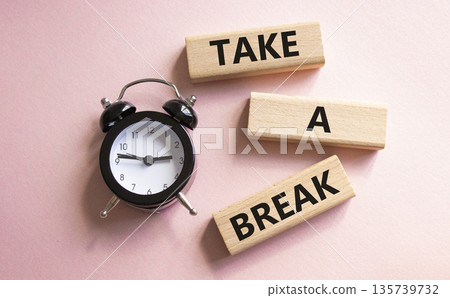 Take a break symbol. Concept words Take a break on wooden blocks. Beautiful pink background with alarm clock. Business and Take a break concept. Copy space. 135739732