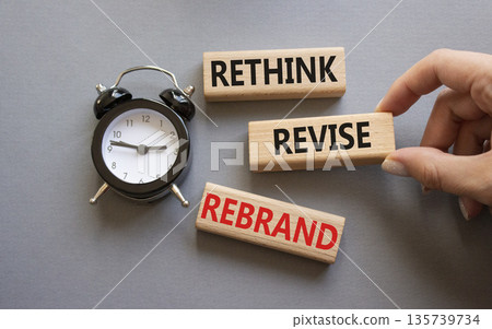 Rethink Revise Rebrand symbol. Wooden blocks with words Rethink Revise Rebrand. Businessman hand. Beautiful grey background with alarm clock. Business and Rethink Revise Rebrand concept. Copy space. Rethink Revise Rebrand symbol. Wooden blocks with words Rethink Revise Rebrand. Businessman hand. Beautiful grey background with alarm clock. Business and Rethink Revise Rebrand concept. Copy space. 135739734