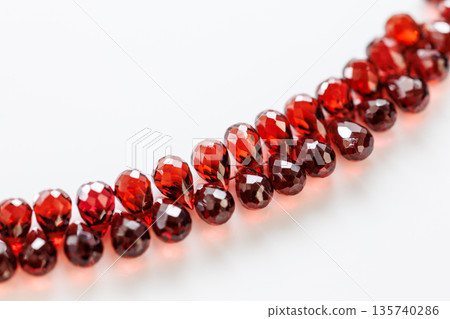 Beautiful teardrop-shaped natural stone beads with deep red garnet 135740286