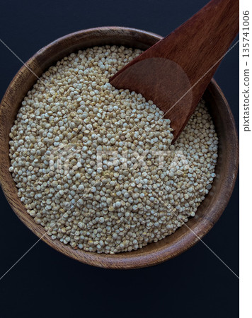 Quinoa Seeds in Wooden Bowl with Scoop Macro Texture Quinoa Seeds in Wooden Bowl with Scoop Macro Texture 135741006