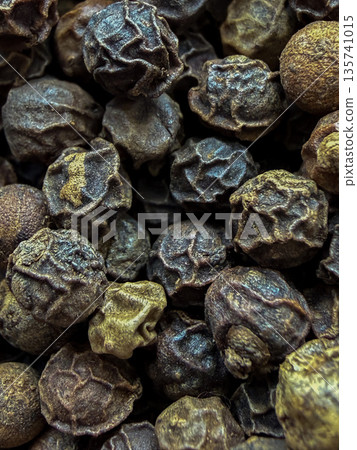 Macro Close-Up of Whole Black Peppercorns Texture Macro Close-Up of Whole Black Peppercorns Texture 135741015