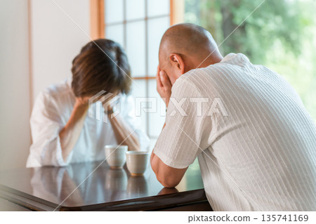 Senior couple holding their heads in shock in a Japanese-style room at home (crying, middle-aged divorce, trouble) Senior couple holding their heads in shock in a Japanese-style room at home (crying, middle-aged divorce, trouble) 135741169