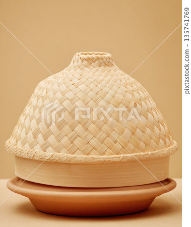 Sticky rice cooked in traditional bamboo steamer creates warm and inviting atmosphere with natural woven texture and earthy tones perfect for Asian cuisine presentation 135741769