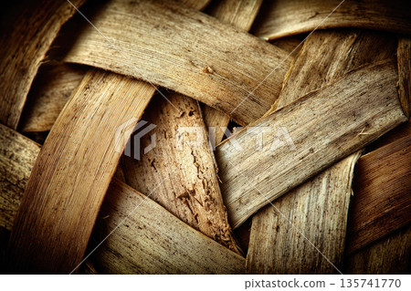 Sticky rice cooked in traditional bamboo steamer creates rustic texture with woven bamboo strips showing natural brown color and organic pattern 135741770