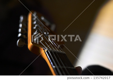 A guitar playing a mellow tune in the darkness 135742017