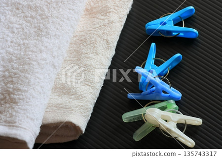 Clothespins and folded towels Clothespins and folded towels 135743317