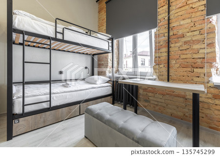 Hostel room with industrial bunk bed and authentic brick wall Hostel room with industrial bunk bed and authentic brick wall 135745299