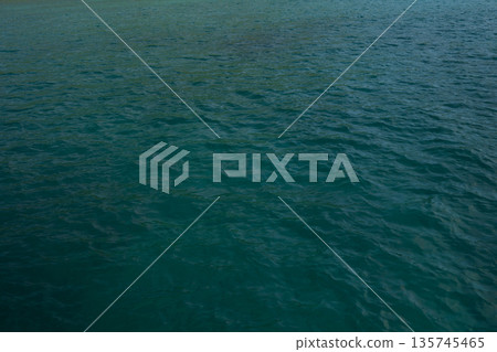 Indian ocean water background in bay on Seychelles islands Indian ocean water background in bay on Seychelles islands 135745465