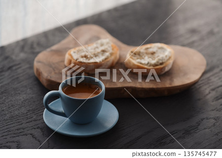 Espresso in blue cup with sandwiches with cream cheese on background Espresso in blue cup with sandwiches with cream cheese on background 135745477