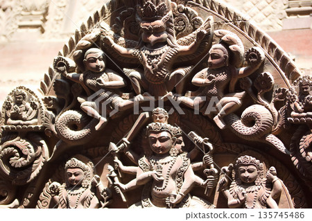 Elaborate wooden carvings of gods found in Nepalese temples (traditional architectural reliefs) 135745486