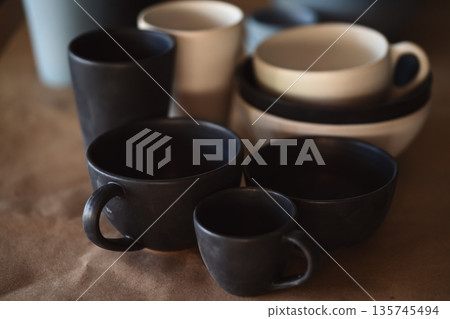 Matt ceramic handmade tableware in a workshop closeup 135745494