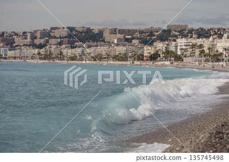 Morning waves on pebble beach in Nice, France Morning waves on pebble beach in Nice, France 135745498
