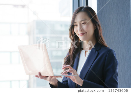 Business woman using a computer Business woman using a computer 135745606