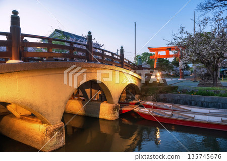 bridge over Yanagawa river to Mihashira Shrine at dusk, Fukuoka 135745676