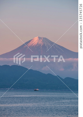 Mt. Fuji with twilight pink sky and sailing cargo container ship, Shimizu 135745716